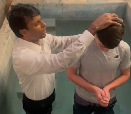 Dylan being baptise by Pastor Shibu Samuel.jpg